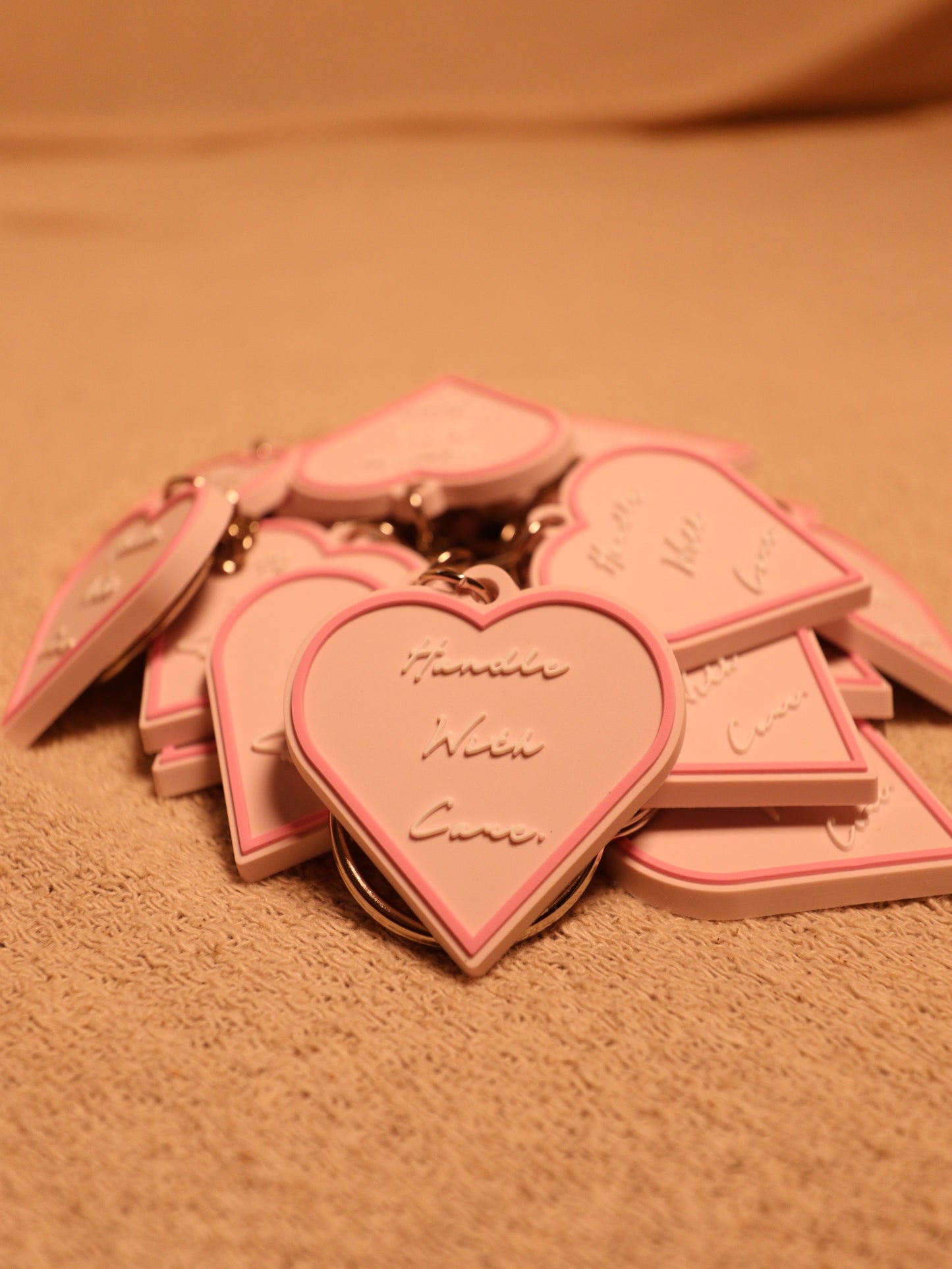 HANDLE WITH CARE KEYRINGS.
